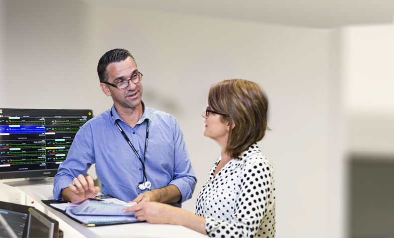 Two practitioners talking in a hospital