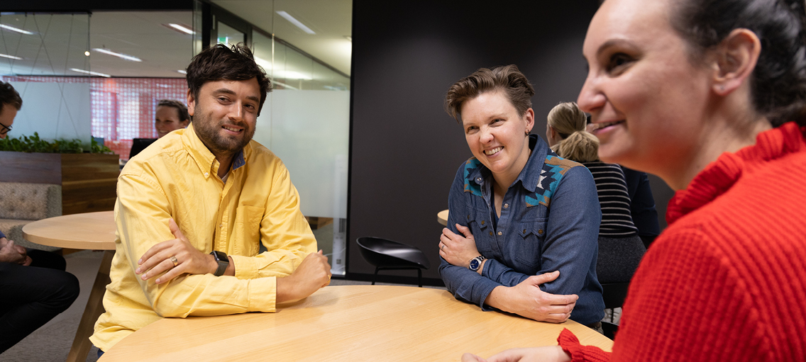 Photo of three staff members in discussion 