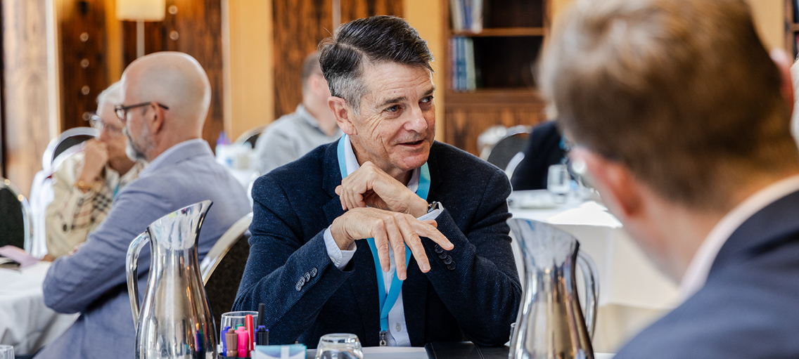 Photo of Ahpra CEO Martin Fletcher at a conference table in discussion